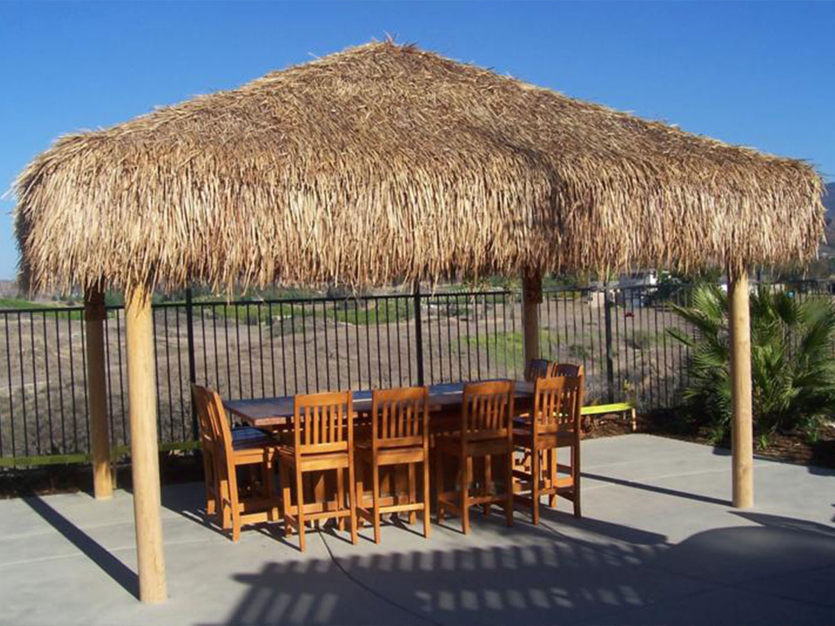 custom outdoor dining area with thatch roofing